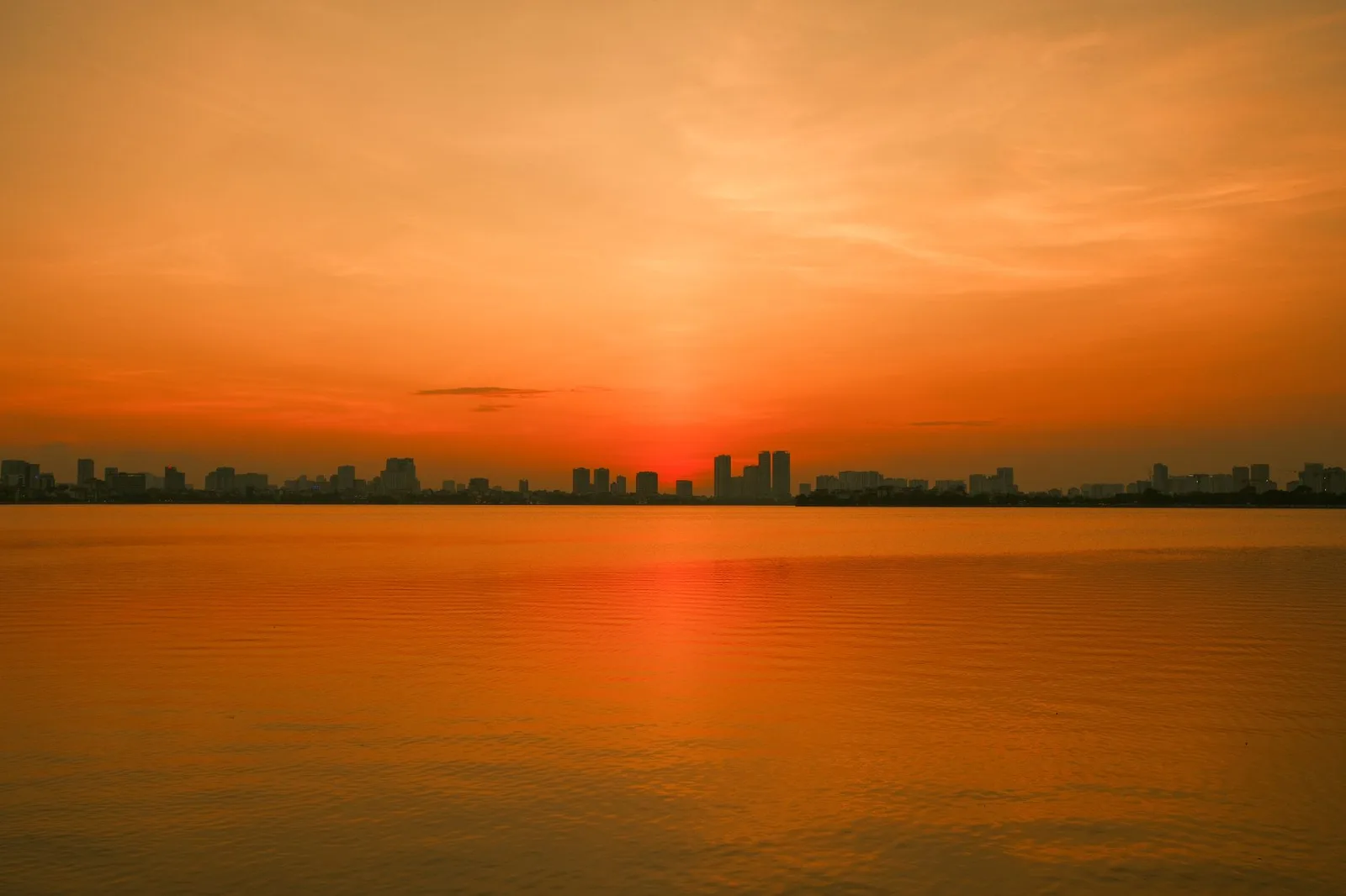 Hanoi city skyline at golden hour overlooking the lake