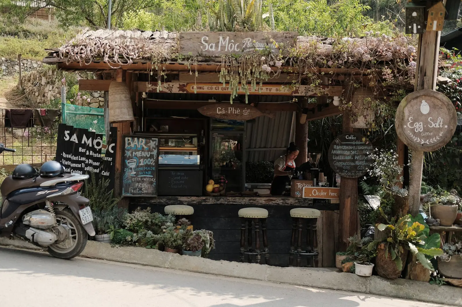 Rustic Hanoi cafe stall serving traditional Vietnamese coffee in daylight